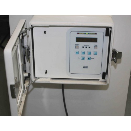 A Goring Kerr DSP1 Metal Detector Head with buttons and display is mounted inside an open white metal wall enclosure.