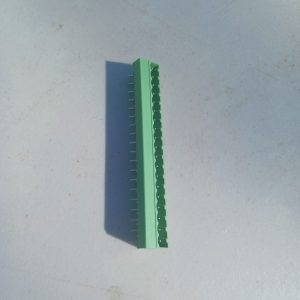 A Header Terminal Blocks 19 Position rests on a light gray surface, casting a shadow to the left.