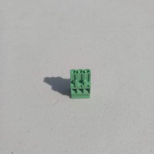 A Pluggable Terminal Blocks 3 Position stands upright on a white surface, casting a shadow to the left.