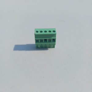 A Pluggable Terminal Blocks 5 Position in green is placed on a light gray surface with its shadow visible.