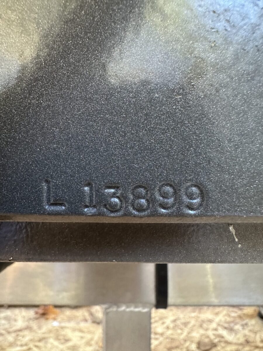 Close-up of the Fortress Belt Stop Conveyor L13899 with "L 13899" stamped into its metal surface.