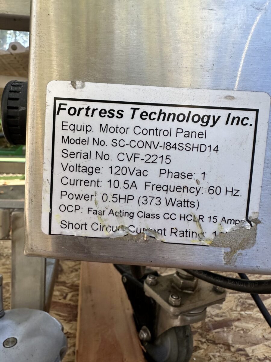 Close-up of a label on Fortress Belt Stop Conveyor L13899 showing technical specs and safety info.